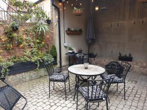 a patio with a table and chairs in a courtyard at Trinity View YORK in York
