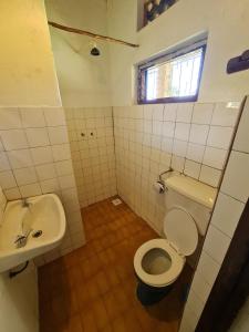 a bathroom with a toilet and a sink at Rwekishokye Country Club in Mbarara