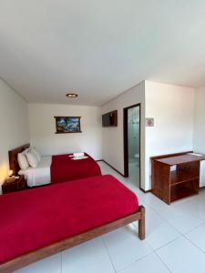 A bed or beds in a room at Pousada Recanto Pontal de Maracaipe