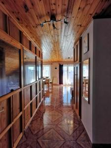 a hallway with a wooden ceiling and a dining room at Júlia Apartman in Balatonalmádi