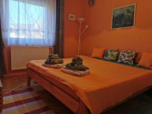 a bedroom with a bed with two animal pillows on it at Júlia Apartman in Balatonalmádi