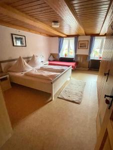 a large bedroom with a bed and a couch at Gasthaus Krone Holzschlag in Bonndorf im Schwarzwald