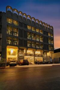 a building with cars parked in front of it at Exora Inn in Ahmedabad