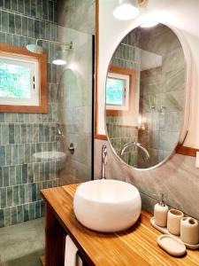 La salle de bains est pourvue d'un lavabo et d'un miroir. dans l'établissement Gaia Nature Lodges at Bluff Beach, à Bocas del Toro