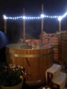 a man and a woman in a hot tub at La Marc'quize in Mouxy