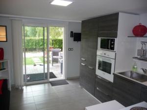 a kitchen with a sink and a stove at Appartement d'une chambre avec jacuzzi terrasse et wifi a Latresne in Latresne