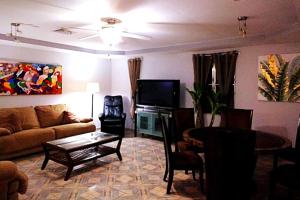 a living room with a couch and a table at Casa Piscina - House with a pool in David in David