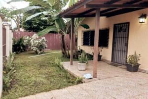 a porch of a house with a wooden pergola at Casa Piscina - House with a pool in David in David