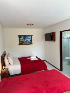 A bed or beds in a room at Pousada Recanto Pontal de Maracaipe