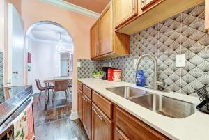 a kitchen with wooden cabinets and a sink at Strawberry Lodge - City card 4 local business in Oklahoma City