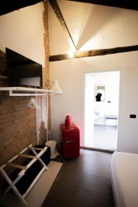a living room with a television and a fireplace at LA CASCINA DEL BALSAMICO b&b in Gaggio