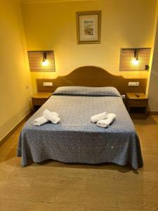 a bedroom with a bed with two towels on it at Hotel Portofino by InsideHome in Empuriabrava +22 photos