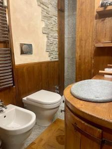 a bathroom with a white toilet and a sink at Mon Bijou in Sauze d'Oulx