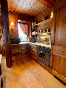 a kitchen with wooden cabinets and a stove at Mon Bijou in Sauze d'Oulx
