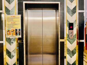 a stainless steel elevator in a subway station at Hotel Aachman Regency with Rooftop Terrace in Shimla