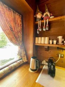 a coffee maker sitting on a table next to a window at Mon Bijou in Sauze d'Oulx