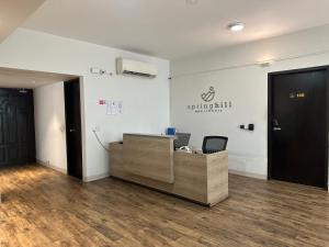 an office with a reception desk and a black door at Spring Hill Hotel & Apartments in Dhaka