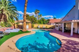 a swimming pool in the yard of a house at Pet Friendly Rancher with Pool/SW Las Vegas in Las Vegas
