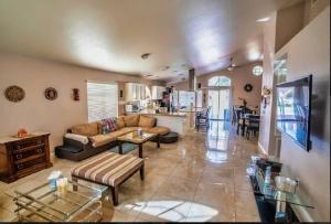 a living room with a couch and a table at Pet Friendly Rancher with Pool/SW Las Vegas in Las Vegas