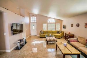a living room with a couch and a table at Pet Friendly Rancher with Pool/SW Las Vegas in Las Vegas