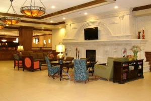 a lobby with a living room with a fireplace at Decatur Conference Center and Hotel in Decatur