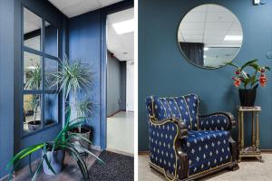 a blue room with a chair and a mirror at Drottninggatans Vandrarhem in Karlskrona