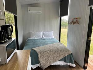 a bedroom with a bed and a large window at Mona Vale Country Estate in Hawarden