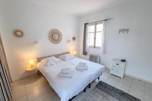 a bedroom with a white bed and a window at HENRI CAMILLE REAL ESTATE - Florida - 2 bedrooms close center in Cannes