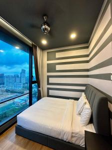 a bedroom with a bed and a large window at Crystal Suite at Opus Kuala Lumpur in Kuala Lumpur