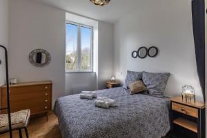 a bedroom with a bed with two stuffed animals on it at Repaire du Bagnérais in Bagnères-de-Bigorre