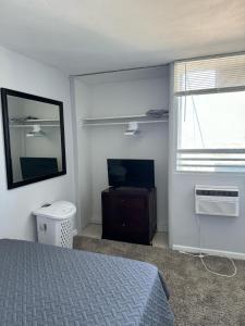a bedroom with a bed and a flat screen tv at 13th Floor Apartment with Nice View in Bahía A in San Juan