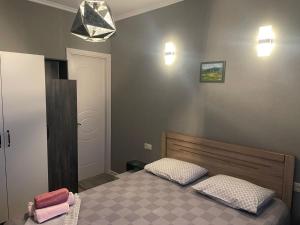 a bedroom with a bed with two pillows on it at panorama in Mtskheta