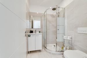 a white bathroom with a shower and a toilet at Lapa Stylish Apartments in Lisbon +35 photos