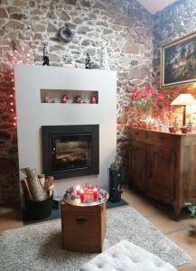 a living room with a fireplace with christmas decorations at Chambre et salle d'eau privées dans maison de ville in La Roche-sur-Yon