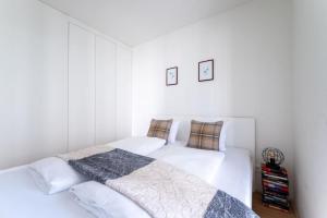 two beds in a bedroom with white walls at HM • Smart Studio with Terrace in Vienna
