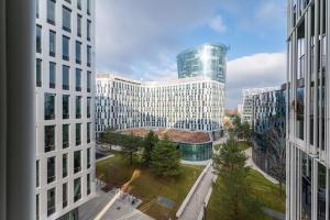 a view of a large building from between two buildings at Smart Studio with Terrace by HM in Vienna