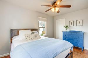 a bedroom with a bed with a blue dresser and a ceiling fan at Downtown Billings Retreat Close to Shops and Eats! in Billings