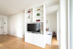 a white living room with a flat screen tv at HM • Smart Studio with Terrace in Vienna