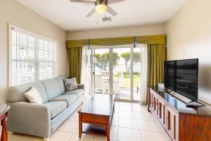 a living room with a couch and a flat screen tv at Restful Retreat in Duck Key