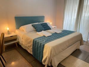 a bedroom with a large bed with a blue headboard at Vatican Apartaments & Rooms - Private Terrace in Rome
