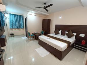 a bedroom with a large bed with a ceiling at Hotel Classic Comfort in Bangalore