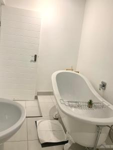 a white bathroom with a tub and a sink at Modern apartment, a home away from home 266 in Summerstrand +13 photos
