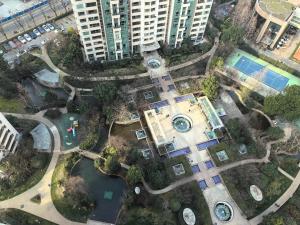 an overhead view of a park with a pool and buildings at Shanghai Downtown Yidu B&B - Near Jing'an Temple Metro Station in Shanghai