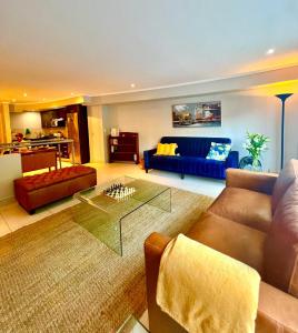 a living room with a couch and a table at Relaxing Seaside Apartment in scenic Houtbay in Cape Town