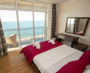 a bedroom with a bed and a large window at SeaGate in Batumi