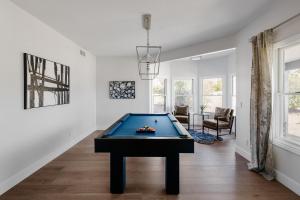 a living room with a pool table in it at Majestic Mountain Mansion - Camelback Views! in Scottsdale