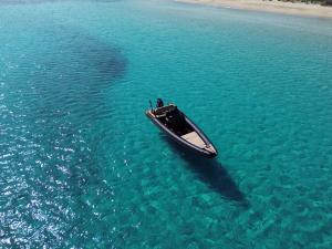a boat in the middle of the water at CycladesCharters: Discover Hidden Gems in Paros! in Kampos Paros
