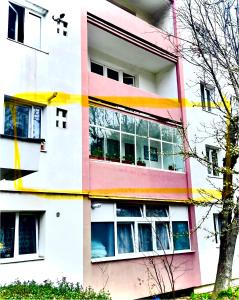 a pink and white building with many windows at Blu Azure in Cluj-Napoca