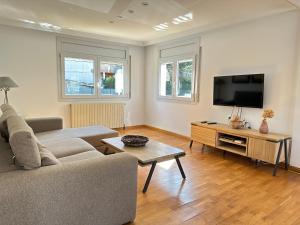 a living room with a couch and a flat screen tv at Agi Riu Segre Villa in Roses