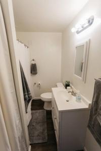 a white bathroom with a sink and a toilet at Stylish & Cozy Home in Dayton-Close to Everything! in Dayton